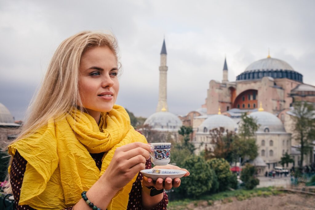 Europe Cruises / Woman with turkish coffee on Hagia Sophia background, Istanbul