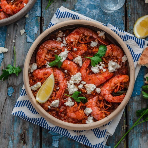 Prawns in tomato sauce with feta cheese, copy space.