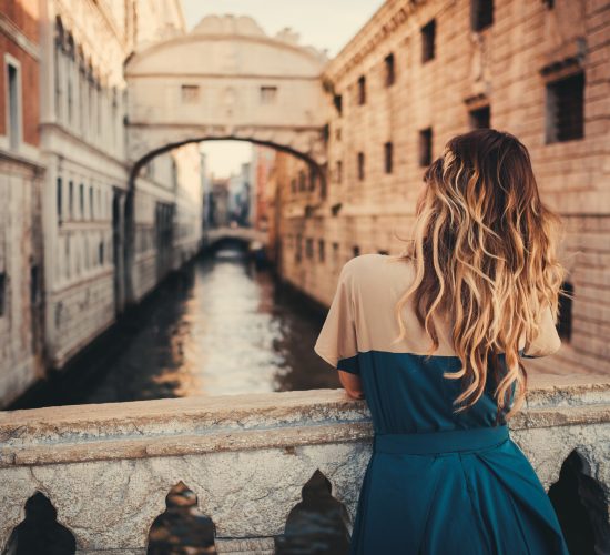 Beautiful woman on a bridge in Venice, Italy.
