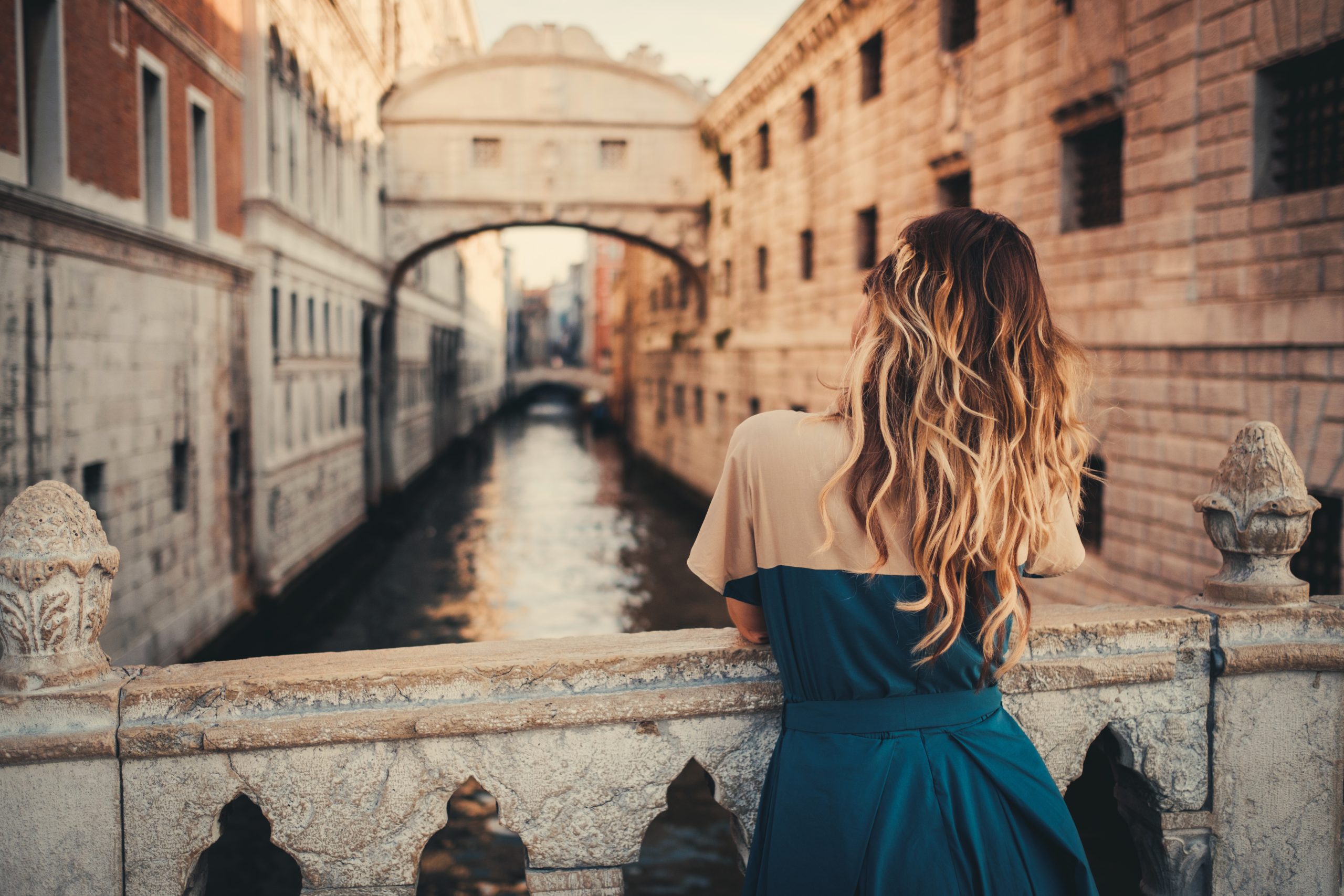 Beautiful woman on a bridge in Venice, Italy.